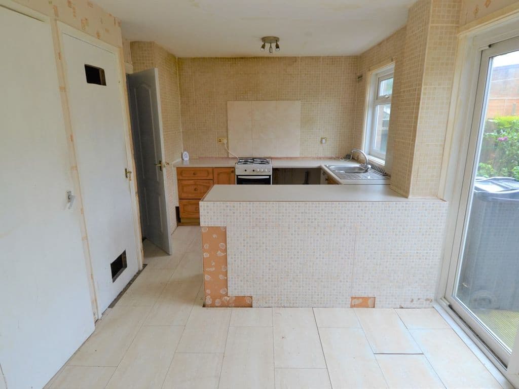 I could see that the kitchen diner did have potential. Those two cupboards on the left needed to go to open up the space. One contained an old floor-standing boiler which was not working.