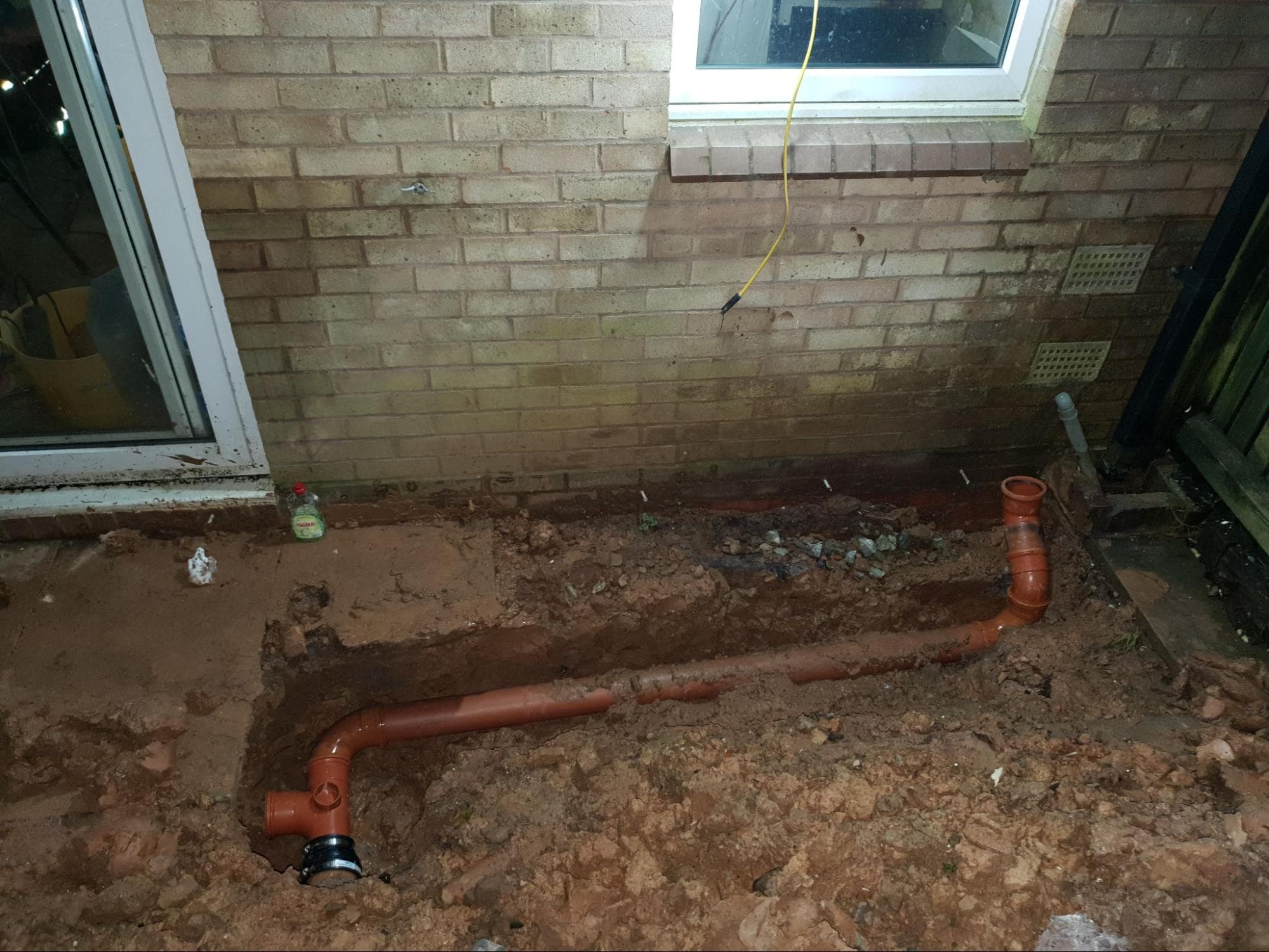 I needed to dig up the garden to lay new soil pipe. You can see here where I added a junction for the downstairs toilet before reburying the pipe. A year or so later, I would excavate it again in order to connect up the downstairs toilet.