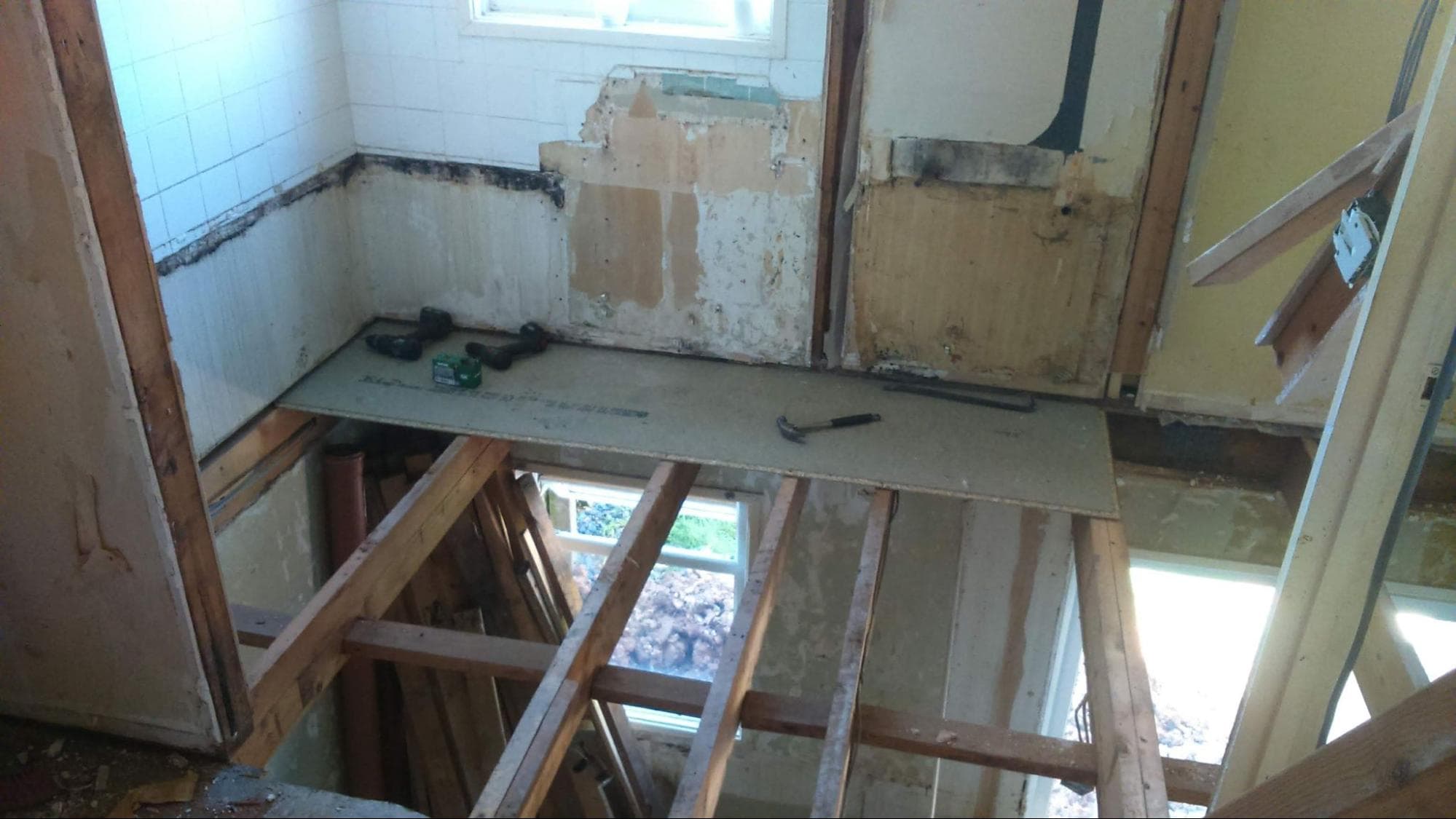 Fresh tongue-and-groove chipboard was screwed and glued into place to completely replace the contaminated upstairs flooring