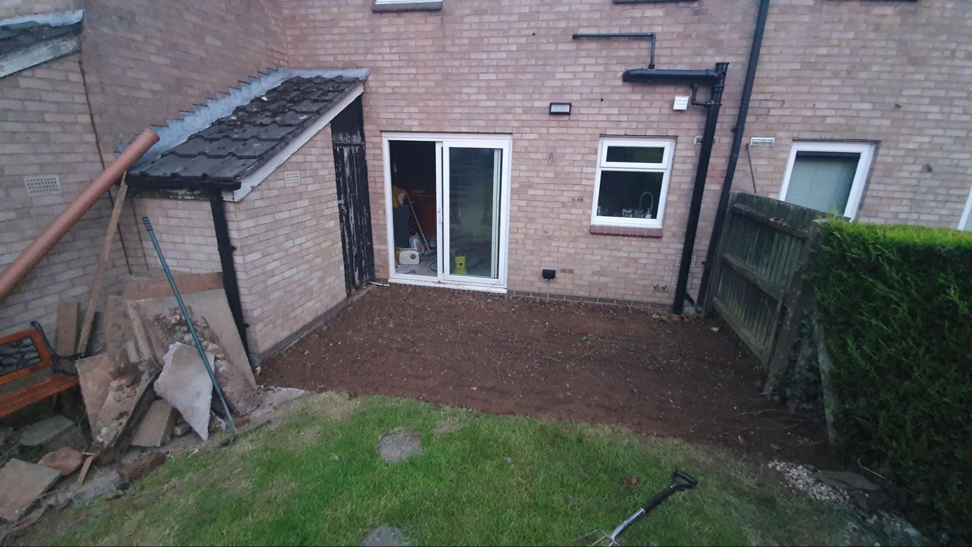 I dug up the old patio and broke up the slabs with a sledgehammer to use as hardcore under the front drive. I would later lay new paving here when renovating the garden.
