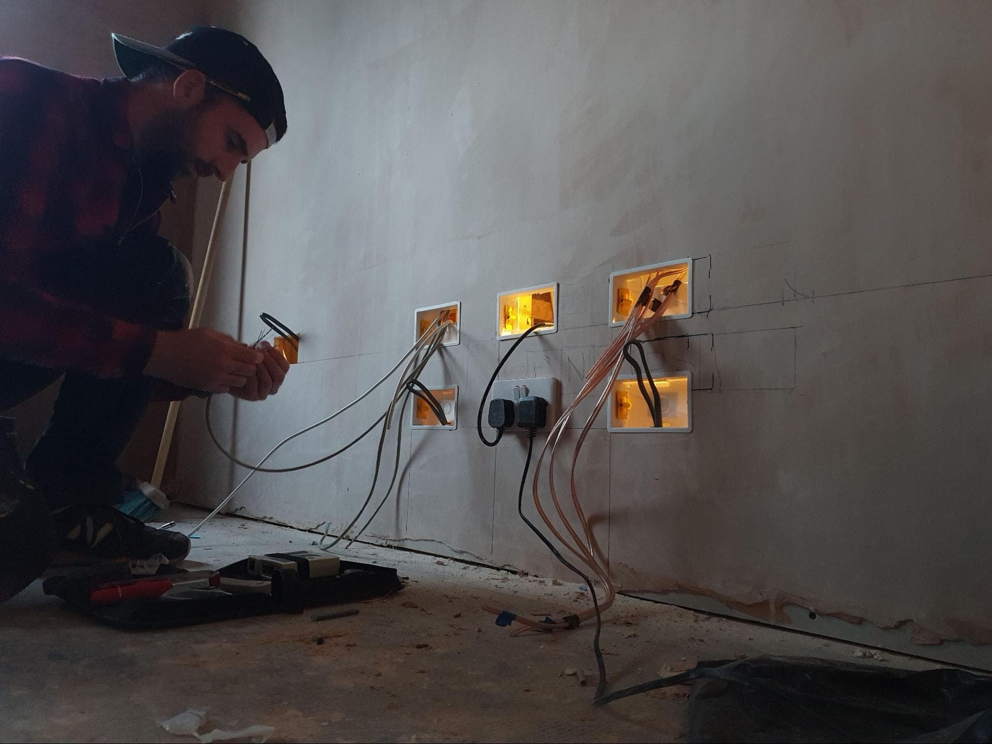 Me terminating wires: The section behind the TV needed terminals for two coax cables (satellite and internet), two ethernet cables, ten speaker cables as well as three double sockets!